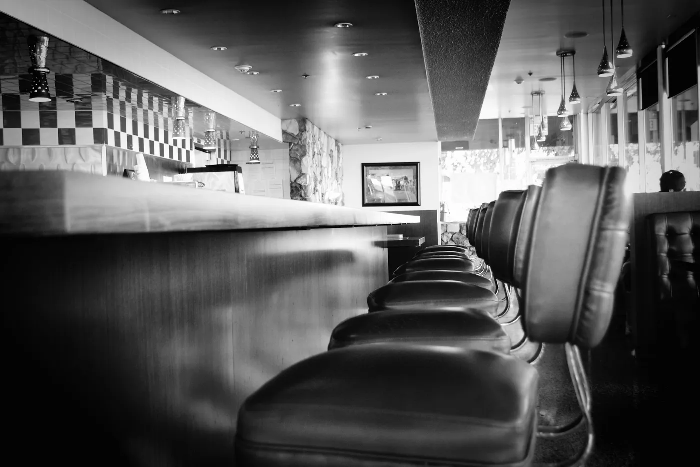 A long diner counter lined with stools